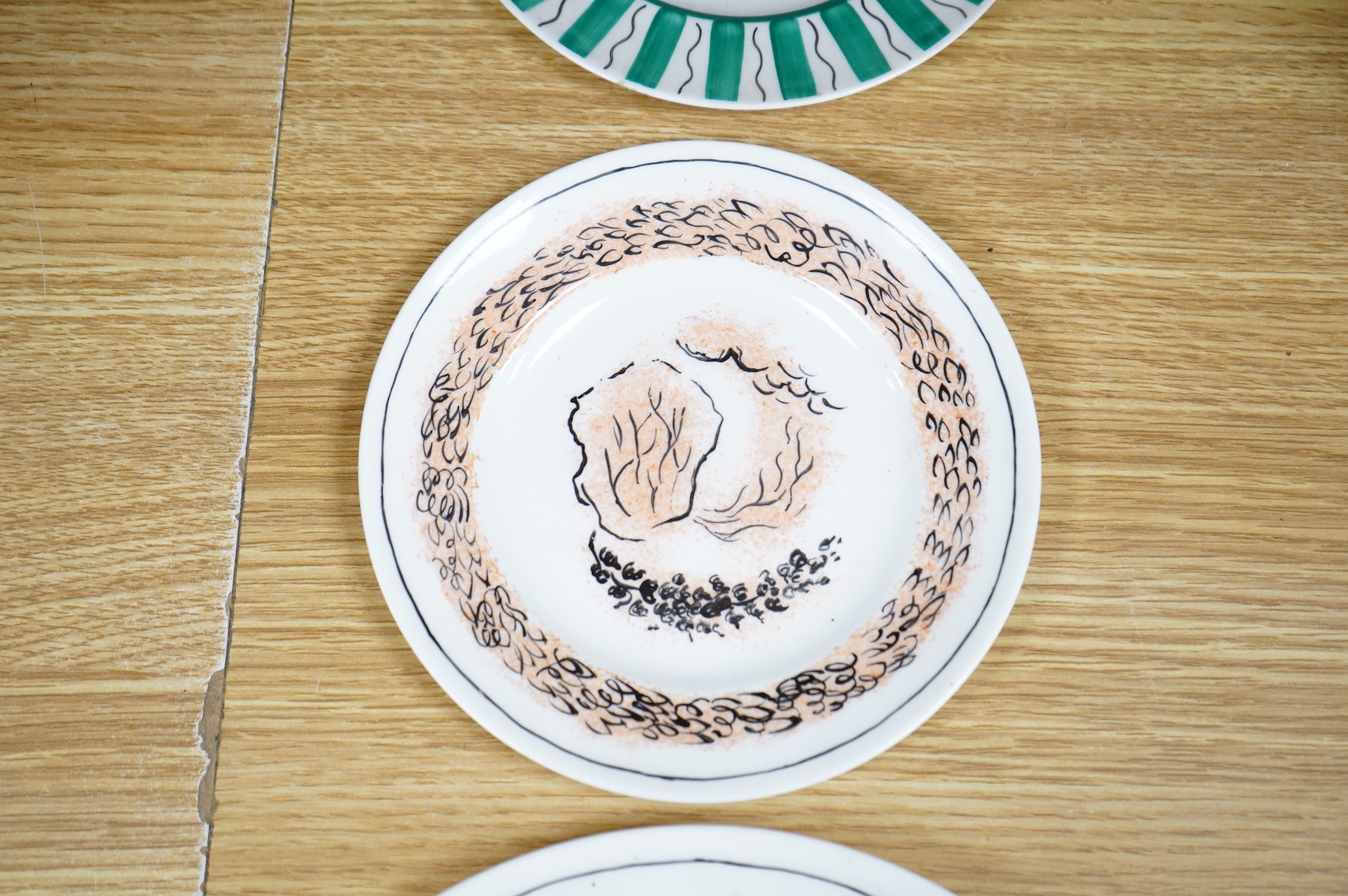 Laura Knight for Foley China cupid plate and matching side plate, together with a Graham Sutherland for Foley China plate and matching side plate, largest 23cm in diameter
